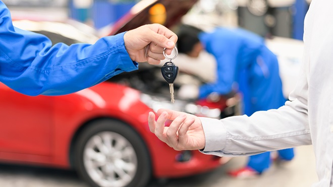 repairer_handing_keys_for_hire_car_to_driver